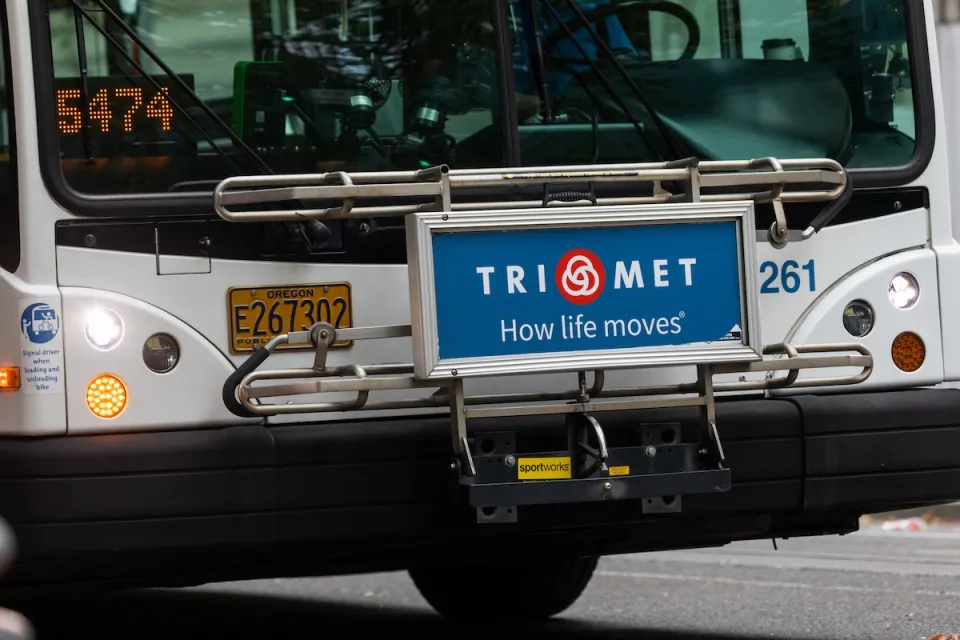 Close-up of front of Portland public bus with TriMet ad on front reading "TriMet: How Life Moves"